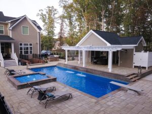 T40 pool with diving board, tanning ledge with bubblers and a spillway, and waterfall